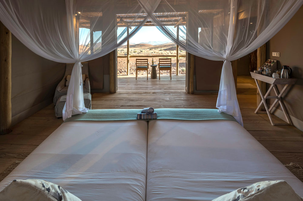 Bedroom at Damaraland Camp, Namibia luxury safari / Dana Allen / Courtesy Wilderness Safaris