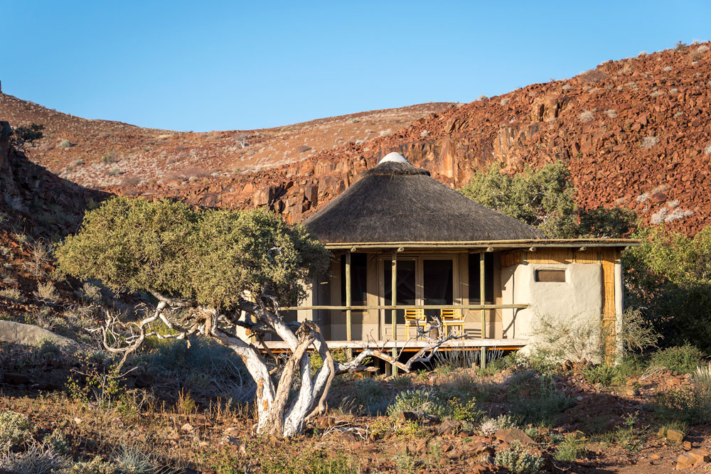 Cabin exterior at Damaraland Camp / Dana Allen / Courtesy Wilderness Safaris