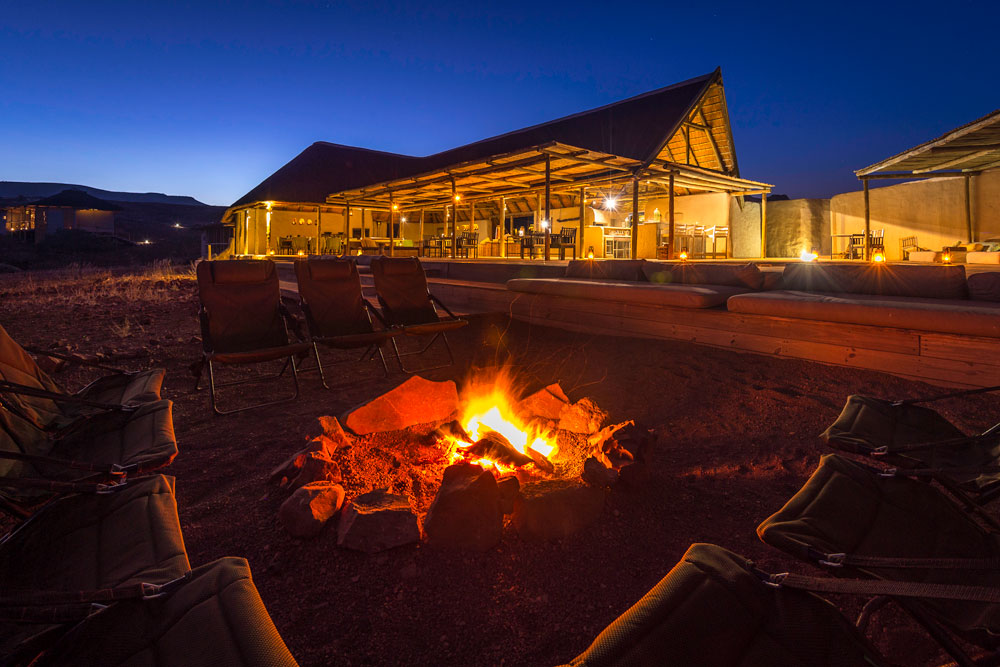 Campfire at Damaraland Camp, Namibia luxury safari / Dana Allen / Courtesy Wilderness Safaris