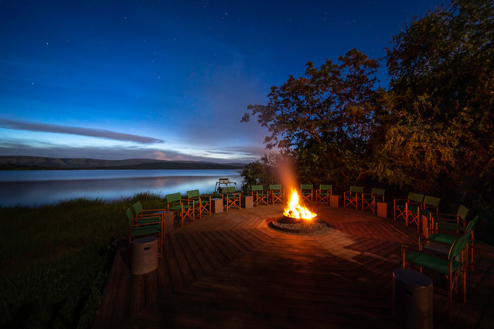 Campfire at Magashi Camp, luxury Rwanda safari / Dana Allen / Courtesy of Wilderness Safaris