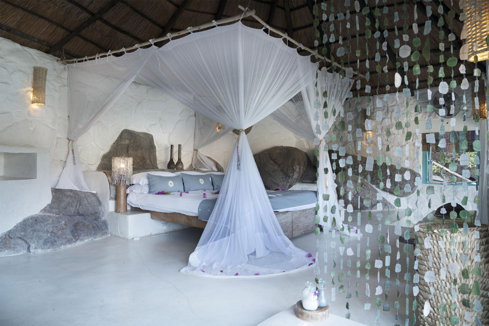 Bedroom at Kaya Mawa / Courtesy of Green Safaris luxury Malawi beach resort