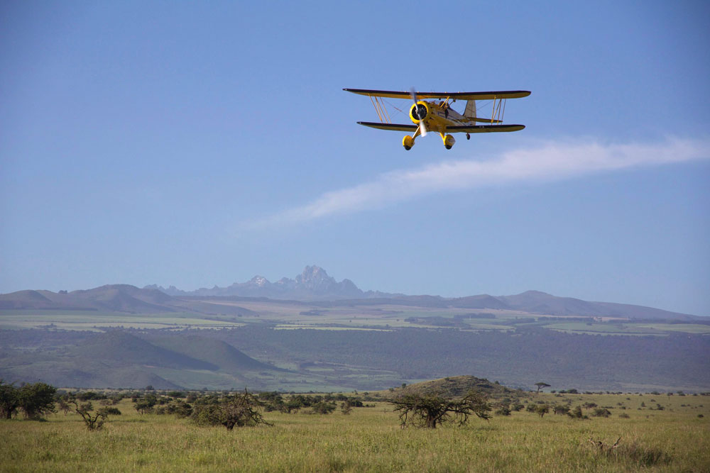 Biplane and Mt. Kenya near Lewa Wilderness / Courtesy of Lewa Wilderness luxury Kenya safari